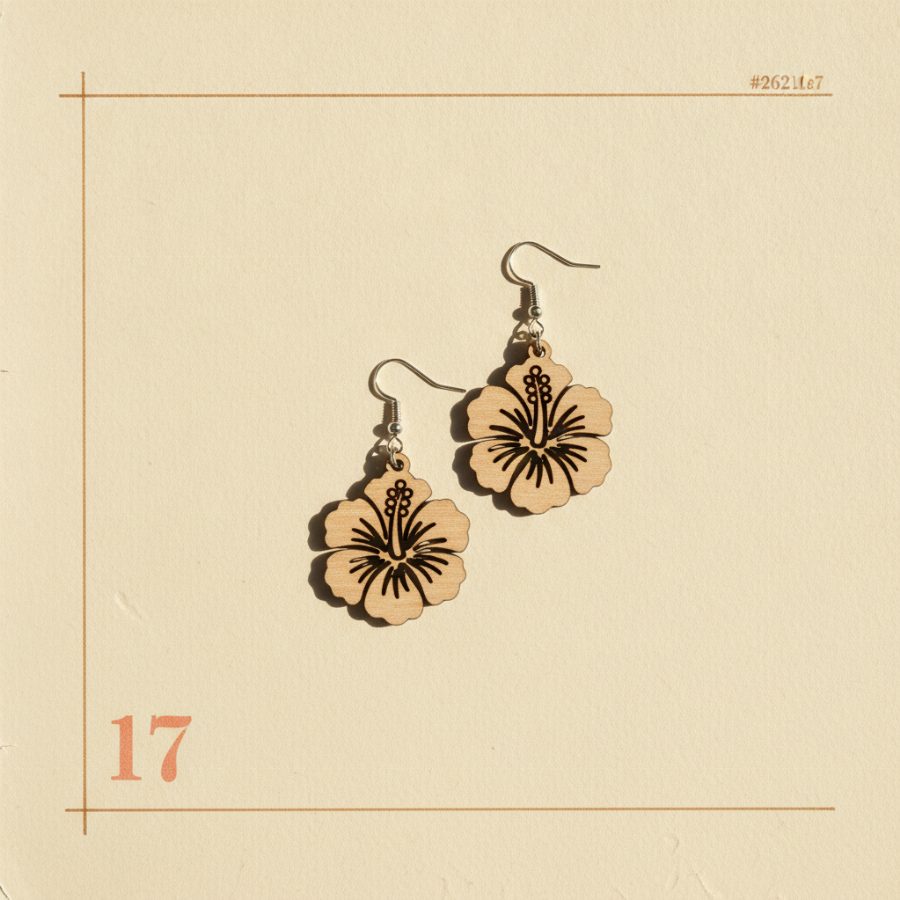 Hand-cut wooden hibiscus drop earrings on paper